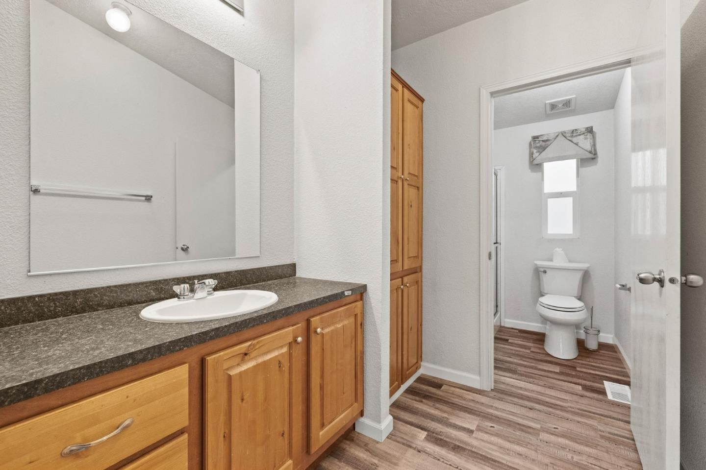 19307 Ferretti Road Groveland, CA 95321 - Photo 14 of 33 a bathroom with a granite countertop sink and a mirror