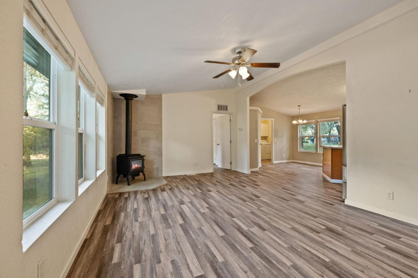 19307 Ferretti Road Groveland, CA 95321 - Photo 3 of 33 a view of empty room with a fireplace and wooden floor