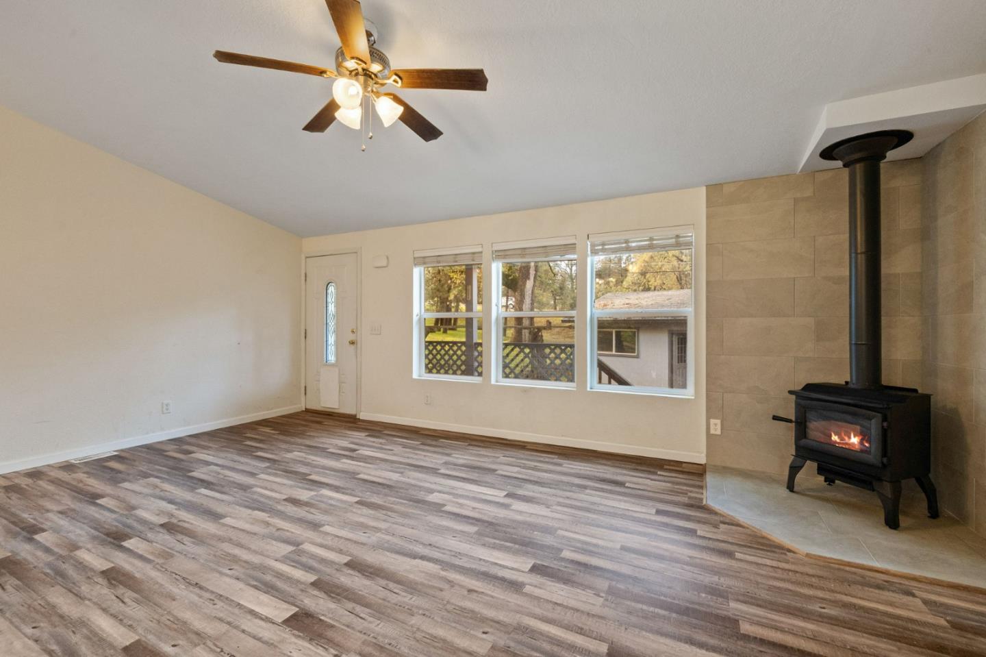 19307 Ferretti Road Groveland, CA 95321 - Photo 5 of 33 a view of a livingroom with wooden floor and a ceiling fan