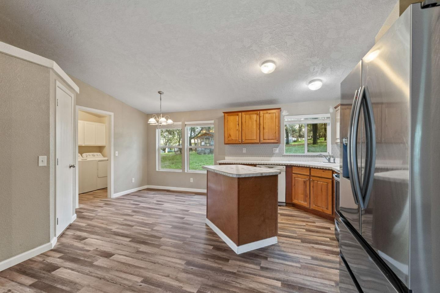 19307 Ferretti Road Groveland, CA 95321 - Photo 6 of 33 a kitchen with granite countertop a refrigerator and a stove top oven