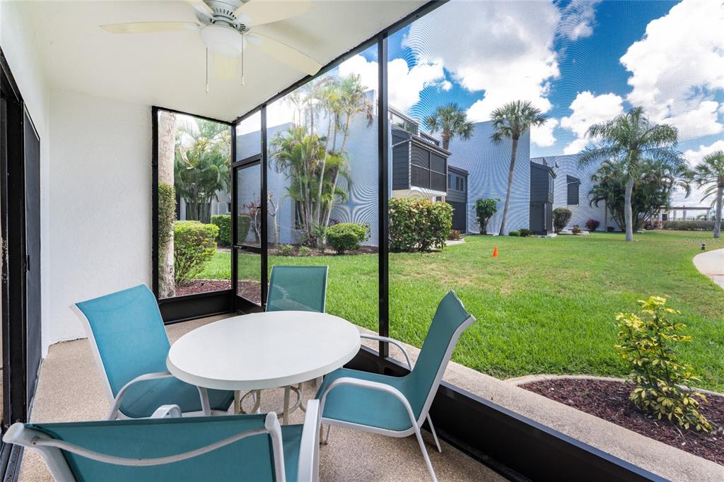 2955 North Beach Road, Unit B614 Englewood, FL 34223 - Photo 13 of 67 a view of a patio with a table chairs and a backyard