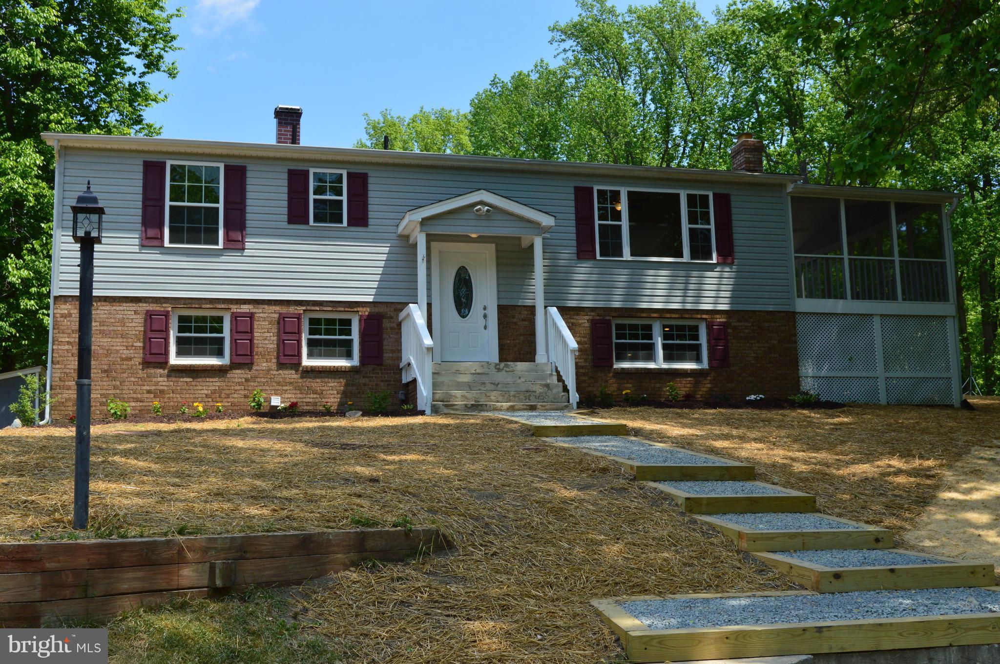 6034 Linden Road St. Leonard, MD 20685 - Photo 1 of 22 a front view of a house with garden