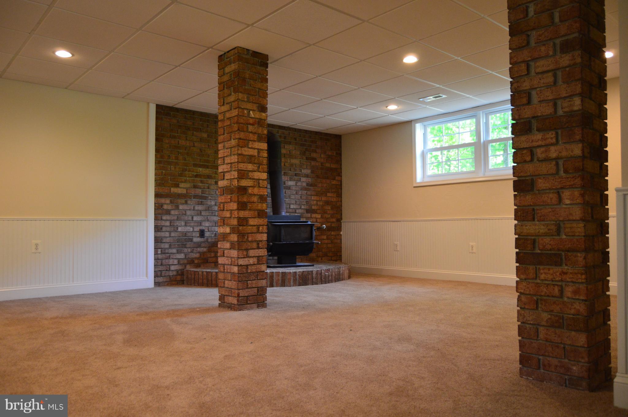 6034 Linden Road St. Leonard, MD 20685 - Photo 14 of 22 a view of an empty room with a fireplace
