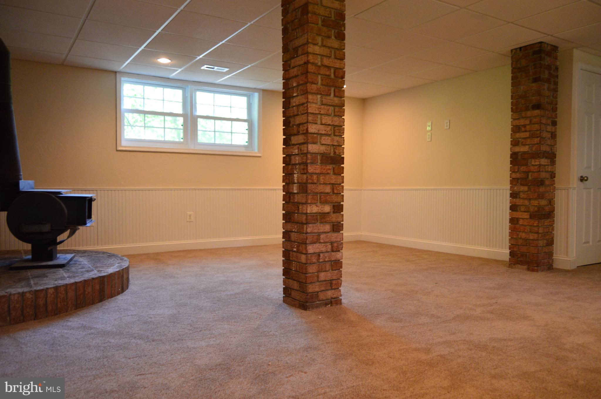 6034 Linden Road St. Leonard, MD 20685 - Photo 15 of 22 a view of an empty room with a fireplace