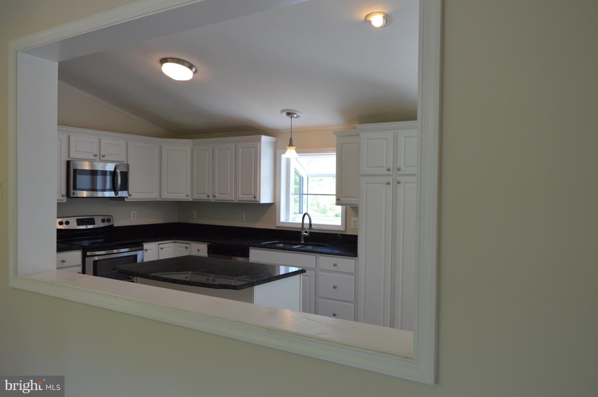 6034 Linden Road St. Leonard, MD 20685 - Photo 7 of 22 a kitchen with granite countertop a sink and cabinets