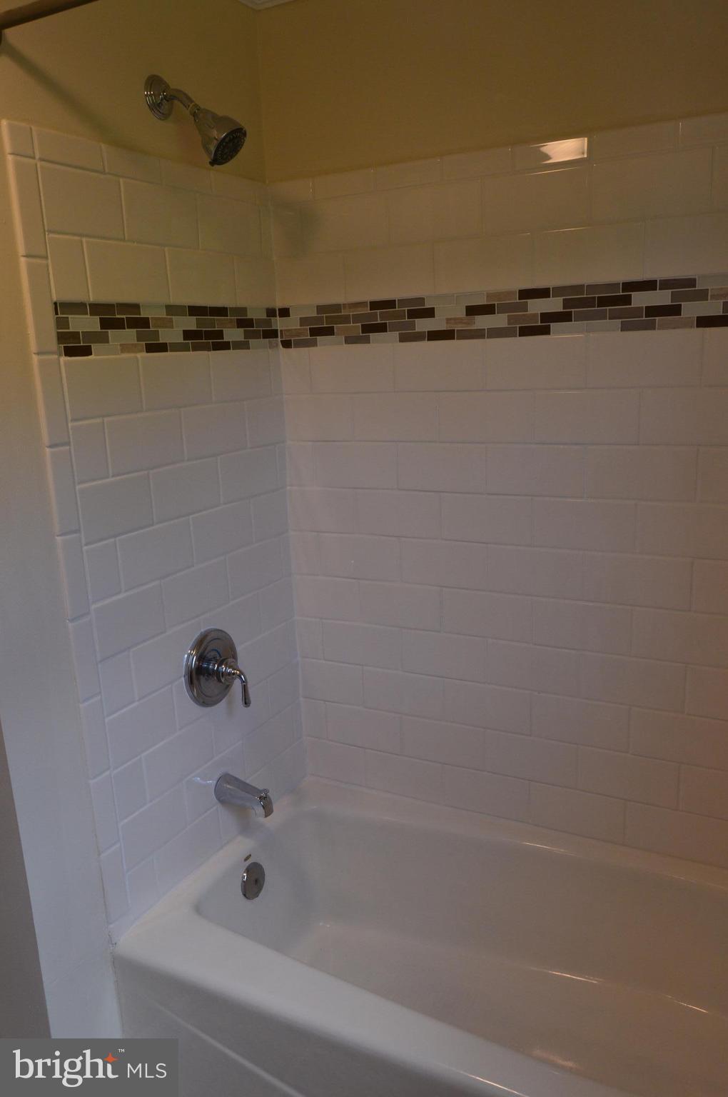 6034 Linden Road St. Leonard, MD 20685 - Photo 9 of 22 a bathroom with a shower and a window