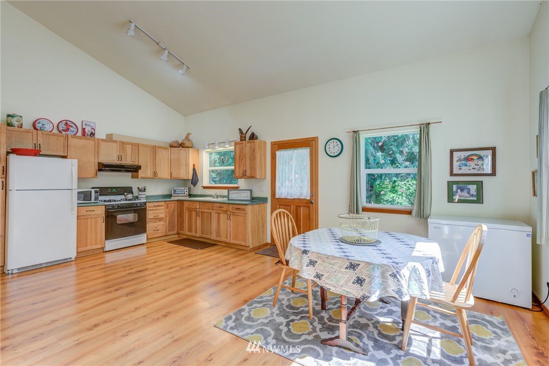 7565 Bear Ridge Way Maple Falls, WA 98266 - Photo 9 of 25 a large kitchen with a table and chairs