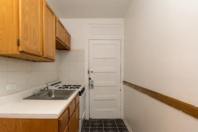 a kitchen with a sink and cabinets