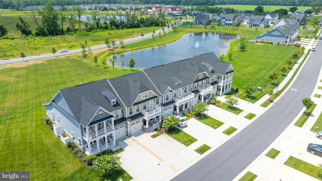 an aerial view of a house with a garden and lake view