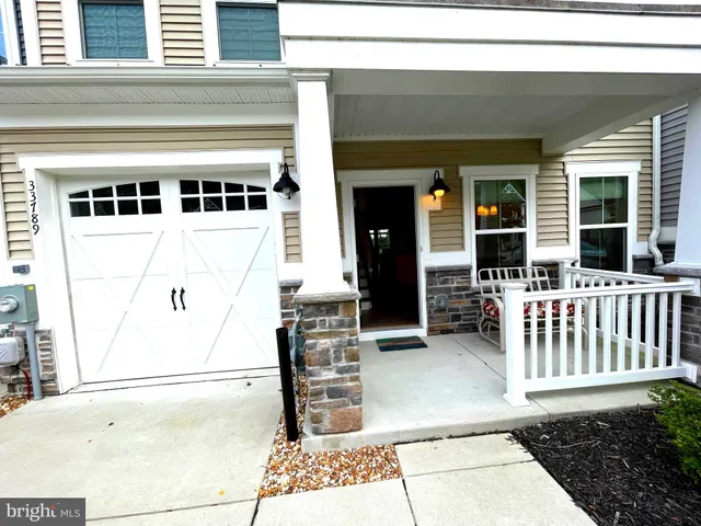 a large kitchen with stainless steel appliances refrigerator a oven and wooden cabinets