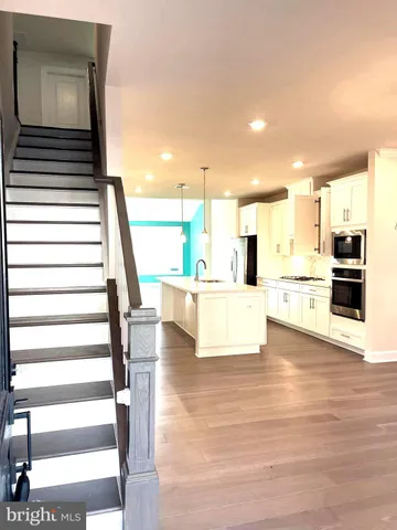 a kitchen with stainless steel appliances a stove a sink and a microwave