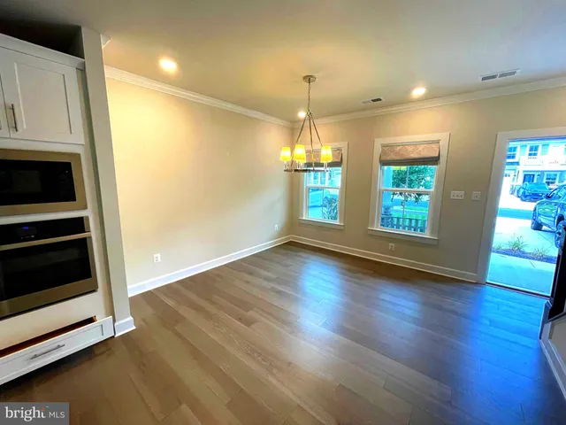 a kitchen with kitchen island a counter top space a sink stainless steel appliances and cabinets