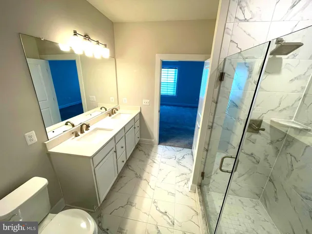 a view of a house with wooden deck and furniture