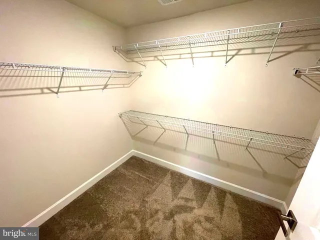 a bathroom with a sink a toilet a mirror and shower