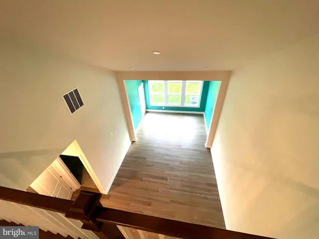 an aerial view of multiple houses with a yard