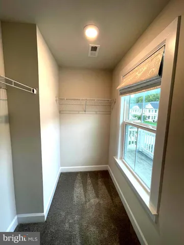 a room with furniture pool table wooden floor and windows