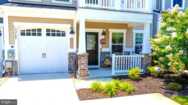 an empty room with wooden floor fireplace and windows