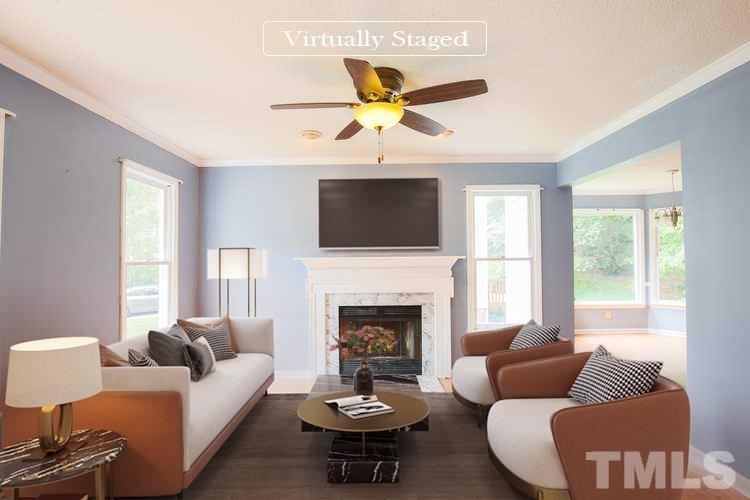 115 Kingsmill Road Cary, NC 27511 - Photo 2 of 19 a living room with furniture a fireplace and a flat screen tv