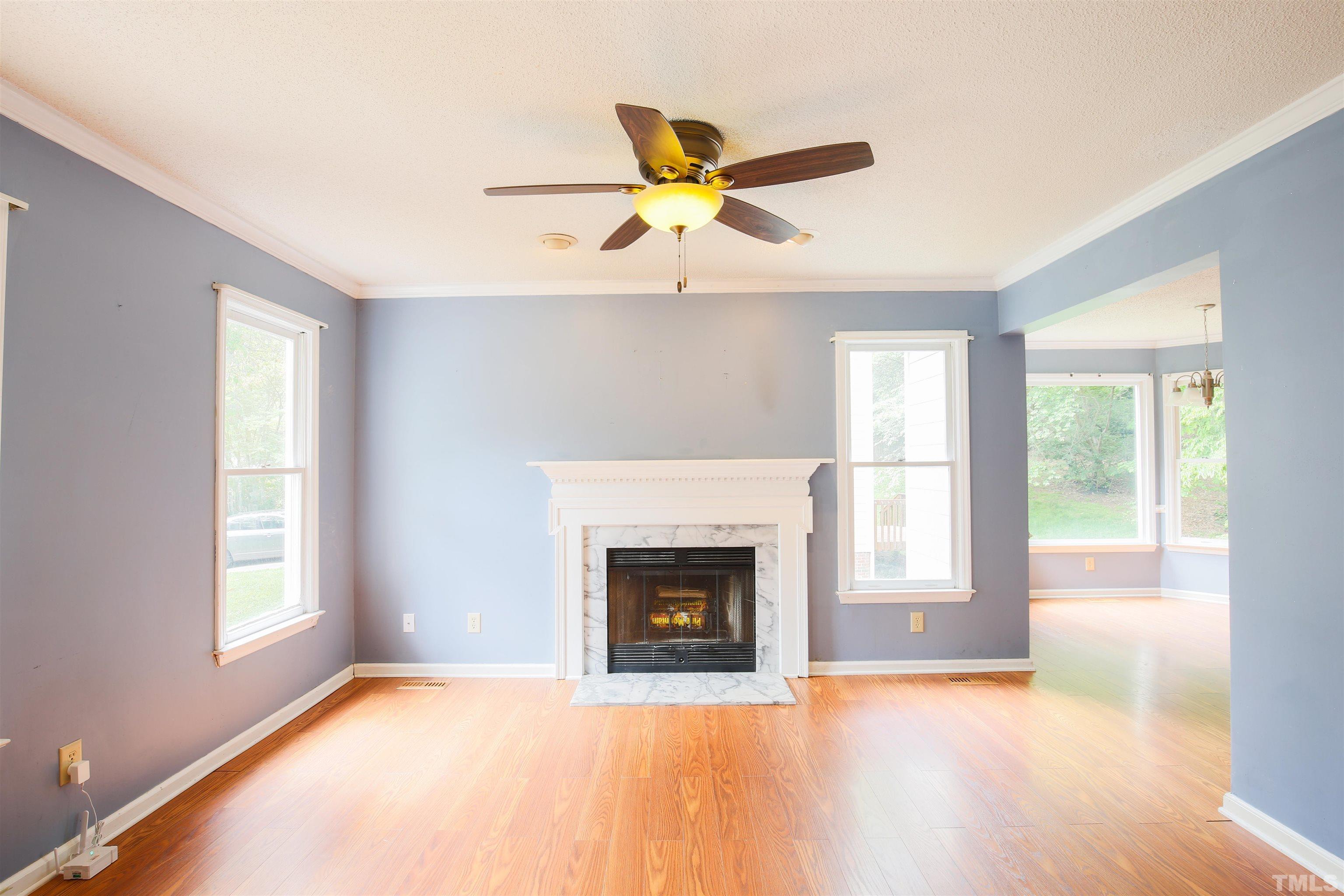 115 Kingsmill Road Cary, NC 27511 - Photo 5 of 19 a view of a livingroom with a fireplace and windows