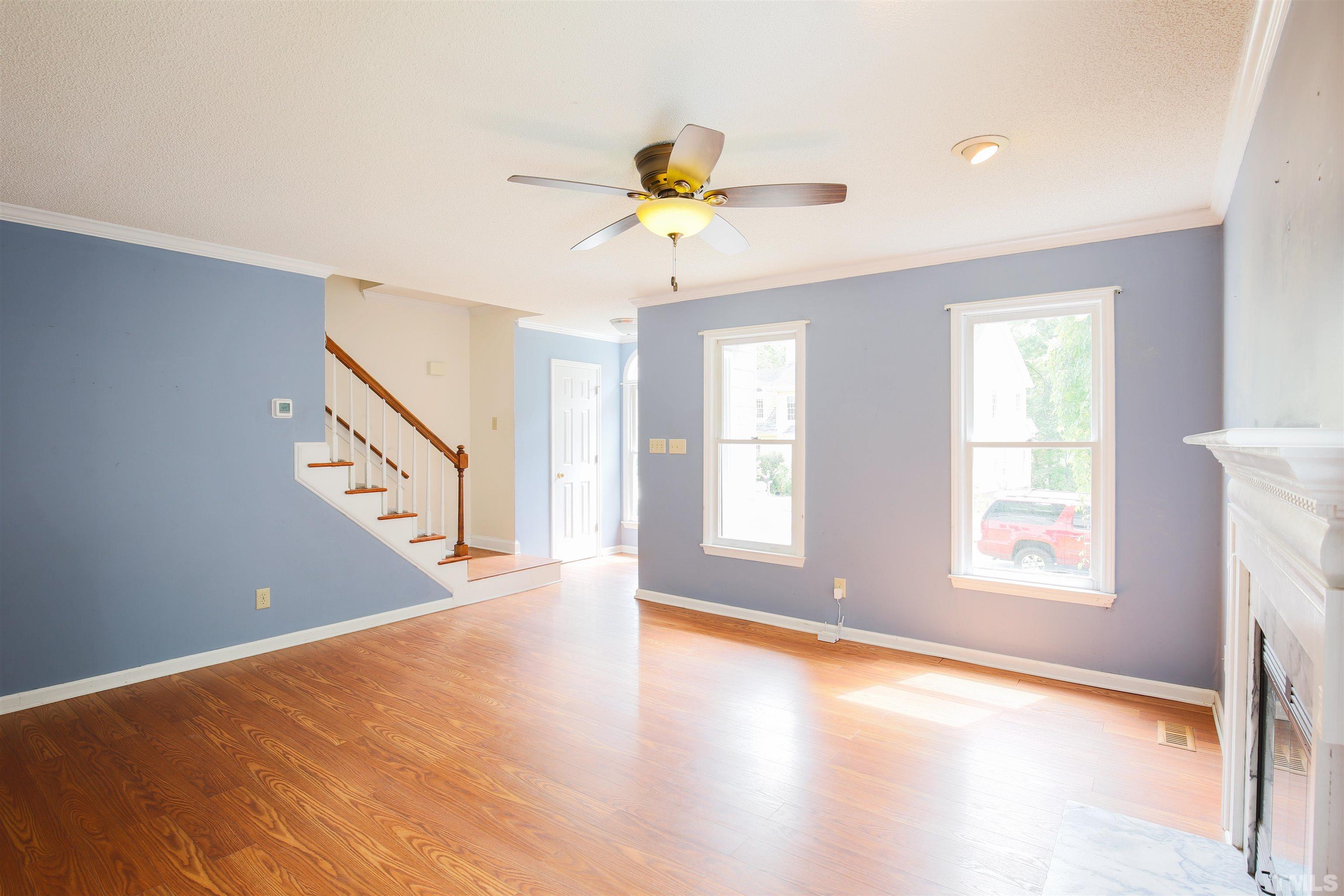 115 Kingsmill Road Cary, NC 27511 - Photo 8 of 19 a view of an empty room with window and wooden floor