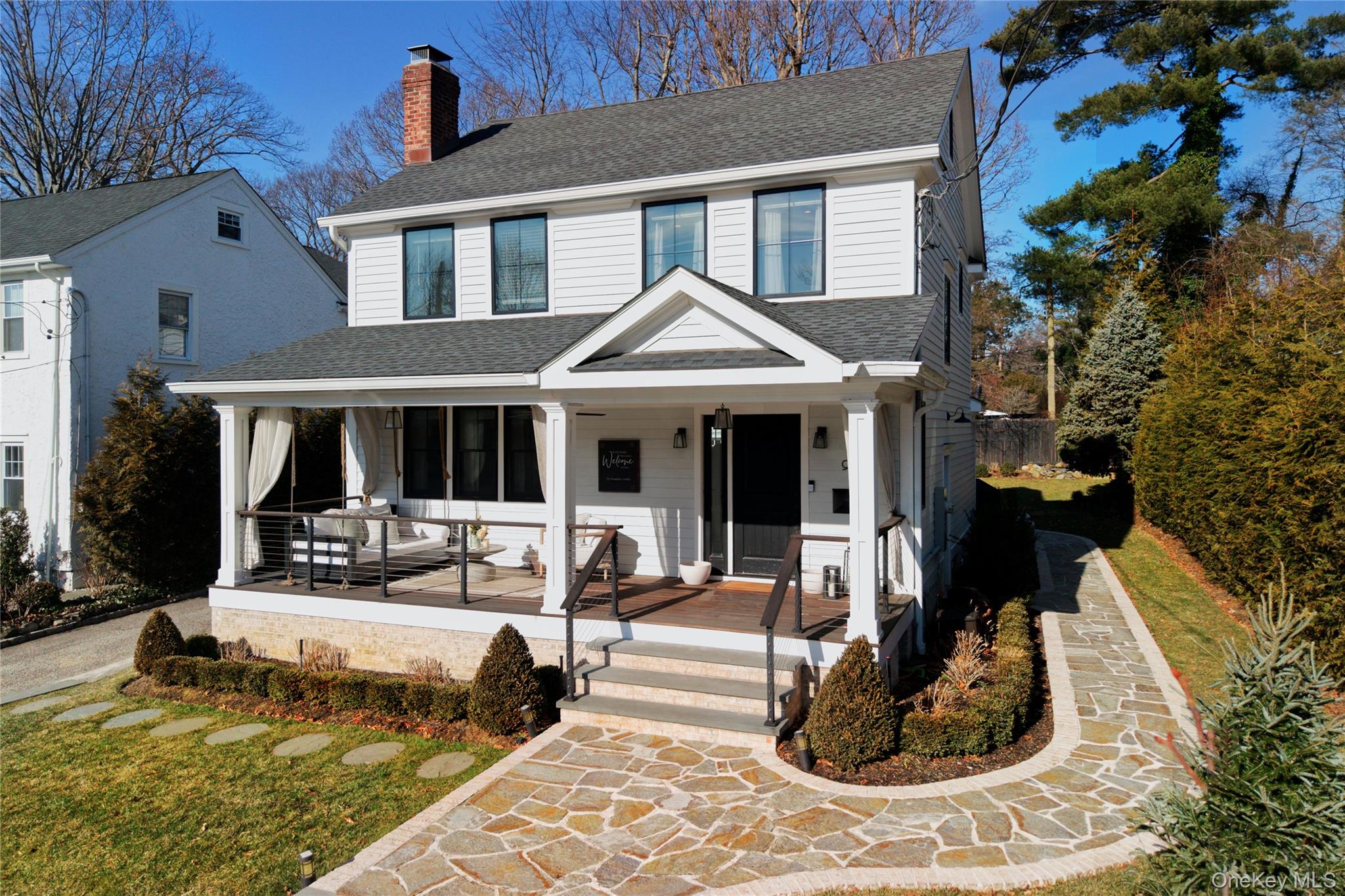 a view of a house with backyard porch and sitting area