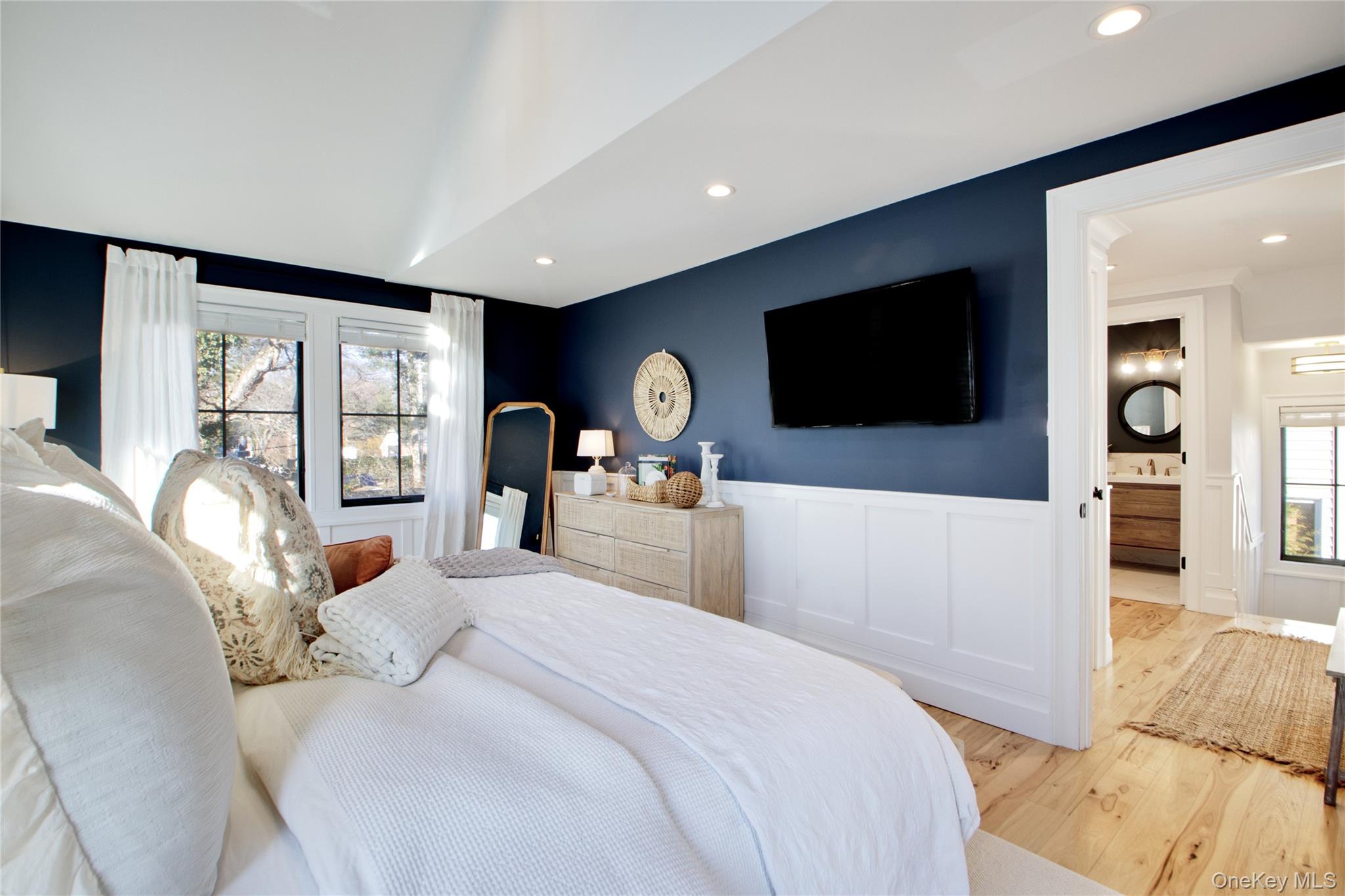 97 Bar Beach Road Port Washington, NY 11050 - Photo 19 of 28 a bedroom with a large bed and a flat tv screen