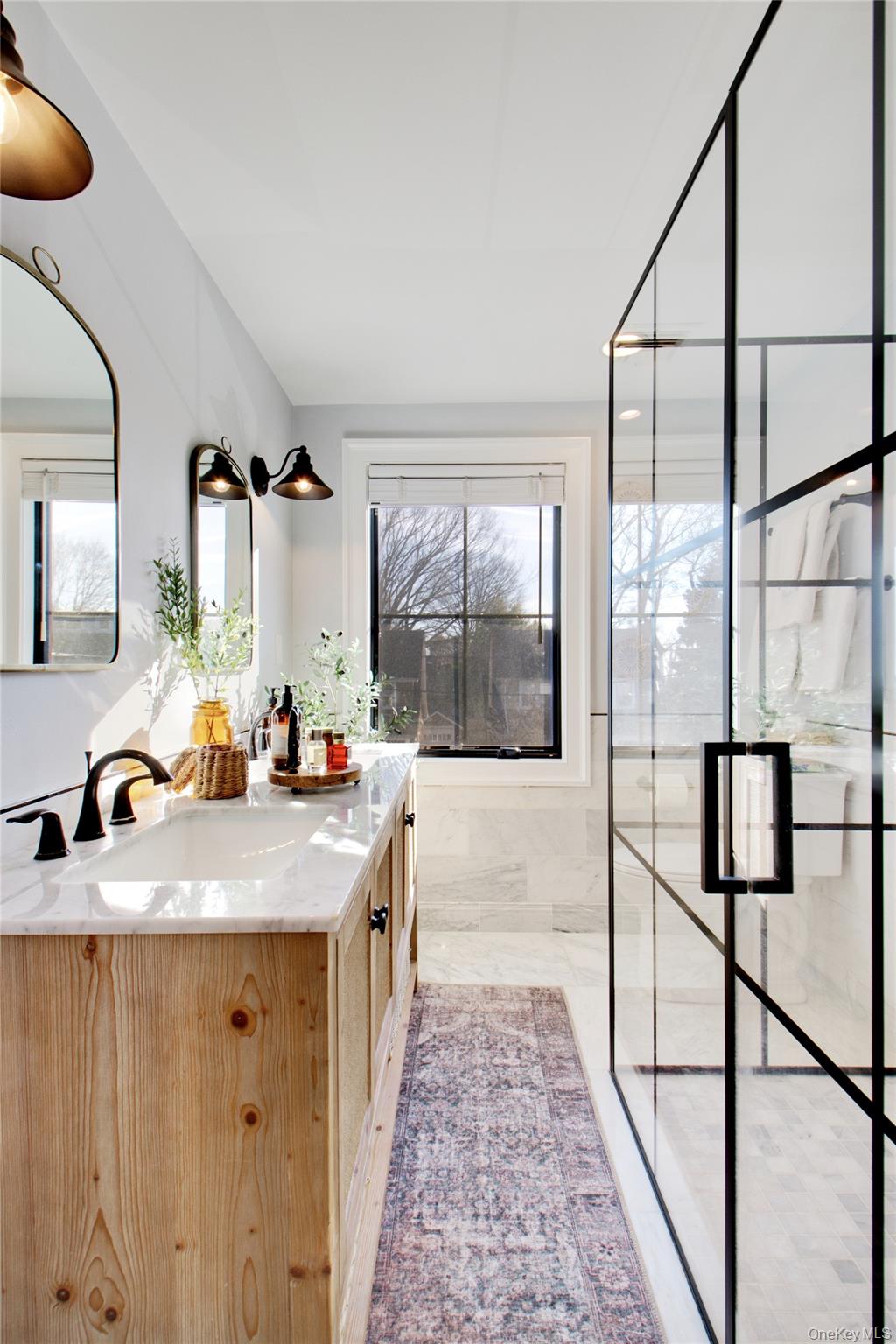 97 Bar Beach Road Port Washington, NY 11050 - Photo 20 of 28 a bathroom with a granite countertop sink and a mirror