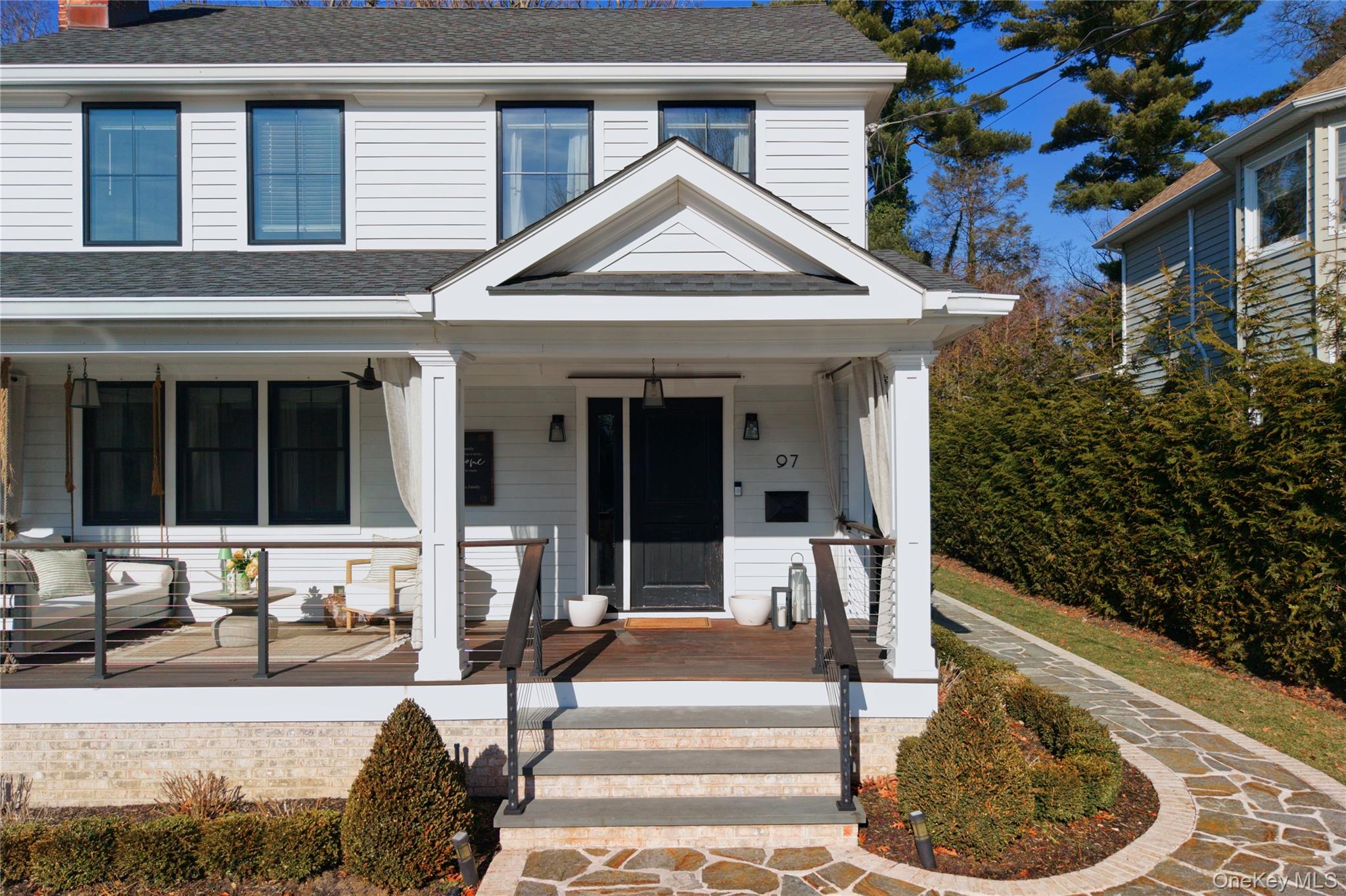97 Bar Beach Road Port Washington, NY 11050 - Photo 2 of 28 a front view of a house with a porch