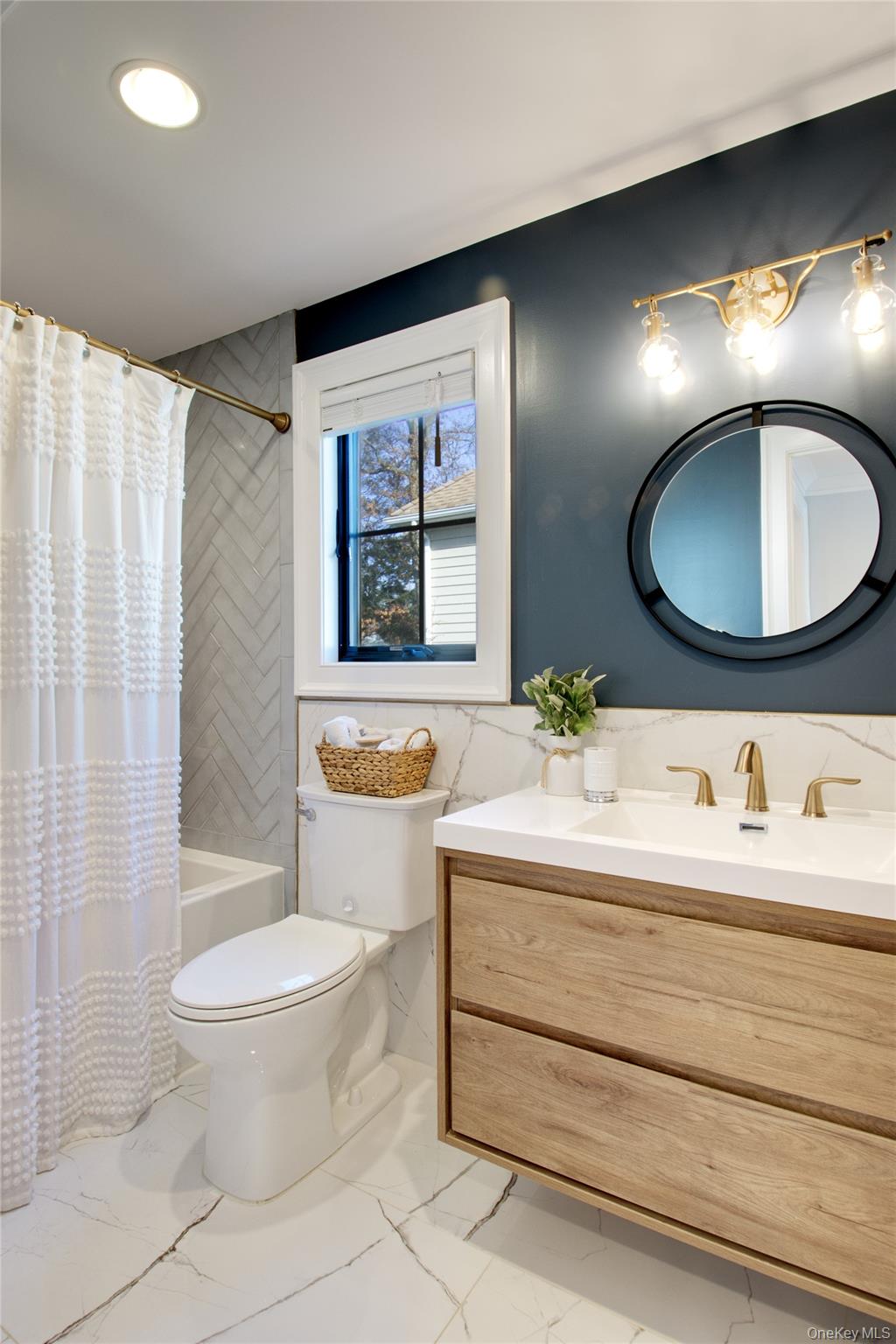 97 Bar Beach Road Port Washington, NY 11050 - Photo 24 of 28 a bathroom with a toilet sink and mirror