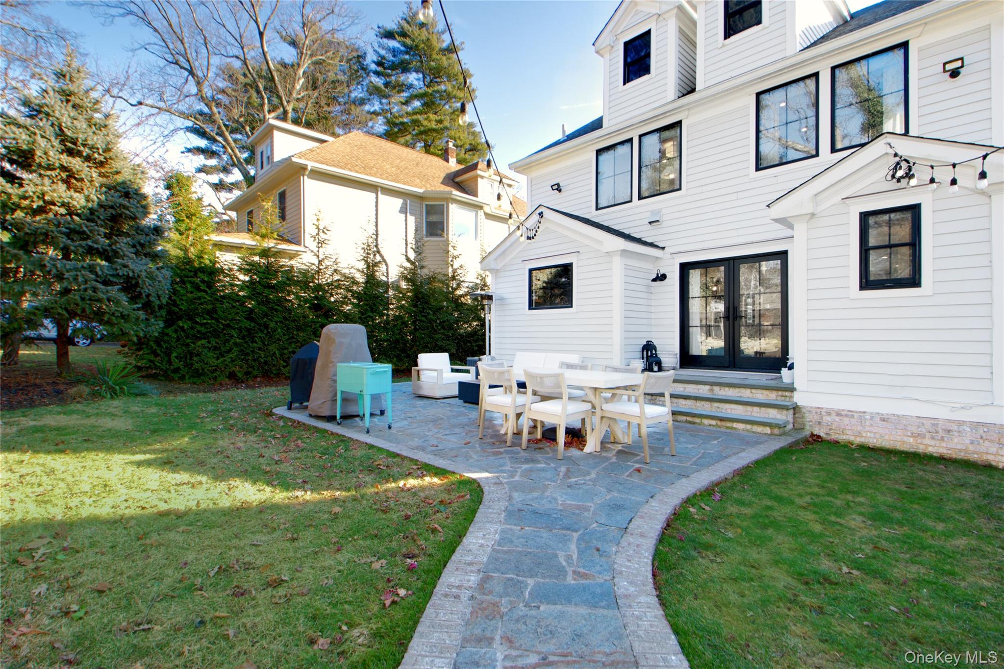97 Bar Beach Road Port Washington, NY 11050 - Photo 26 of 28 a view of a house with backyard and sitting area