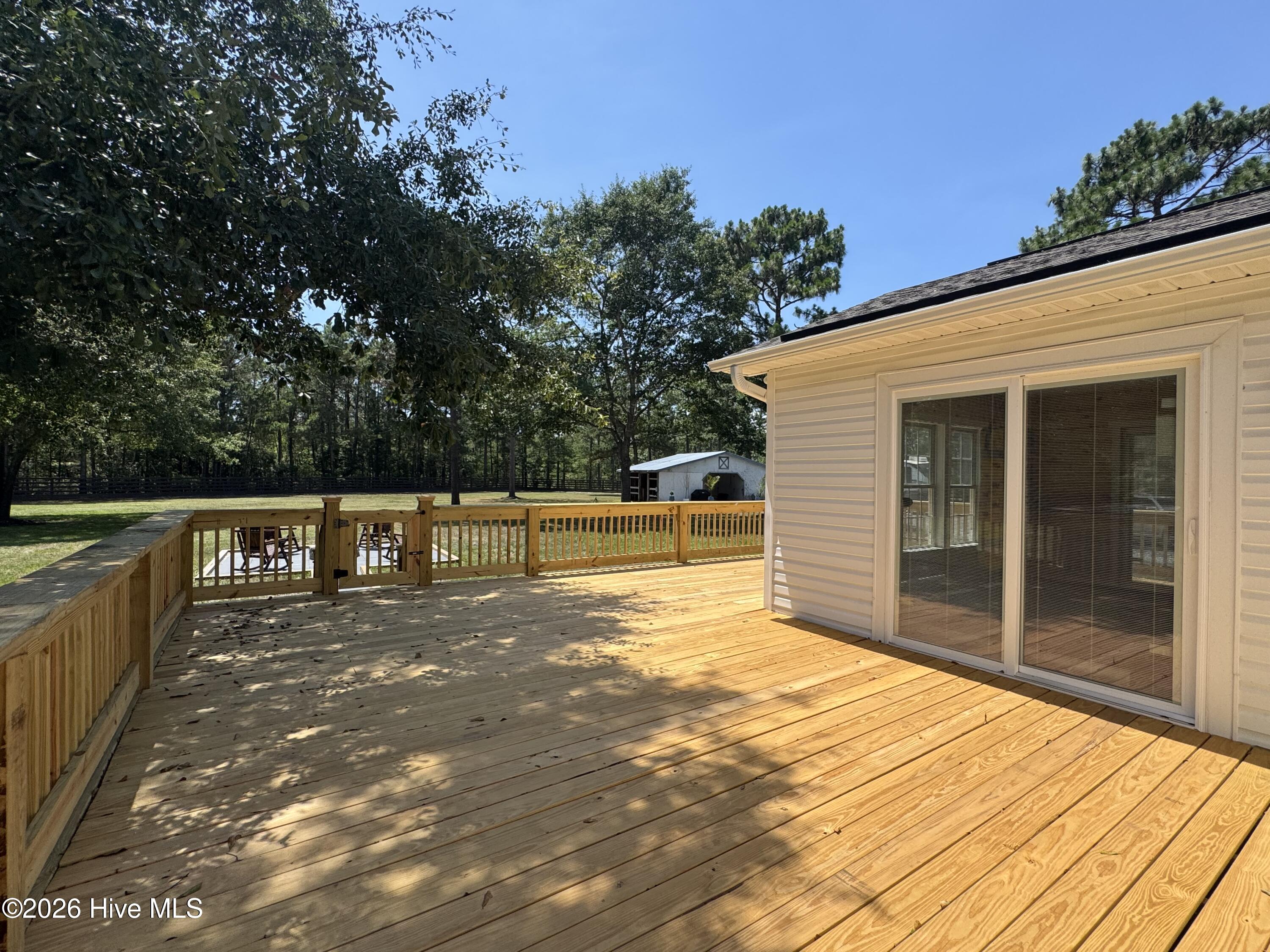 1265 Gilbert Road Southeast Bolivia, NC 28422 - Photo 8 of 46 Sliding glass door open up to a bright and airy sunroom