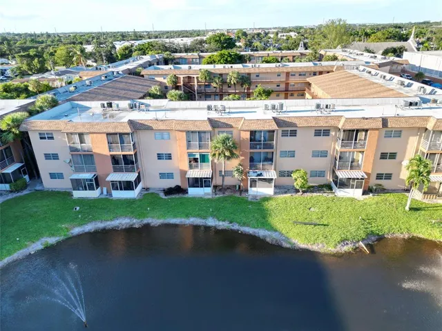 an aerial view of a house with a yard basket ball court and outdoor seating