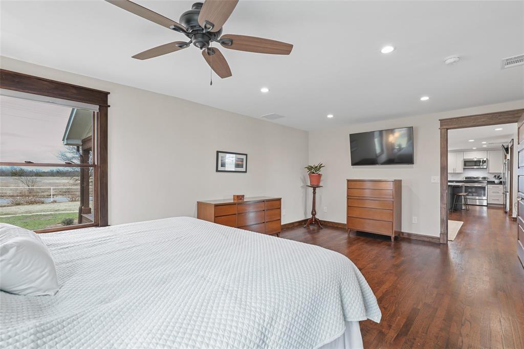 2196 Bledsoe Road Gunter, TX 75058 - Photo 18 of 33 a bedroom with a bed and a flat screen tv