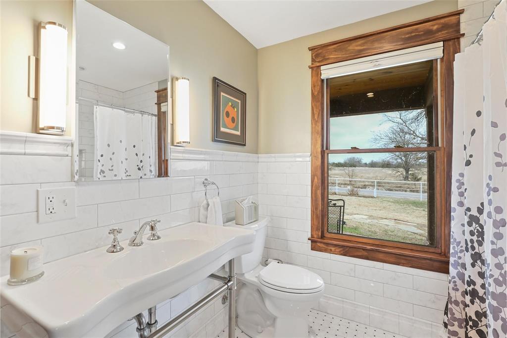 2196 Bledsoe Road Gunter, TX 75058 - Photo 25 of 33 a bathroom with a sink toilet and shower