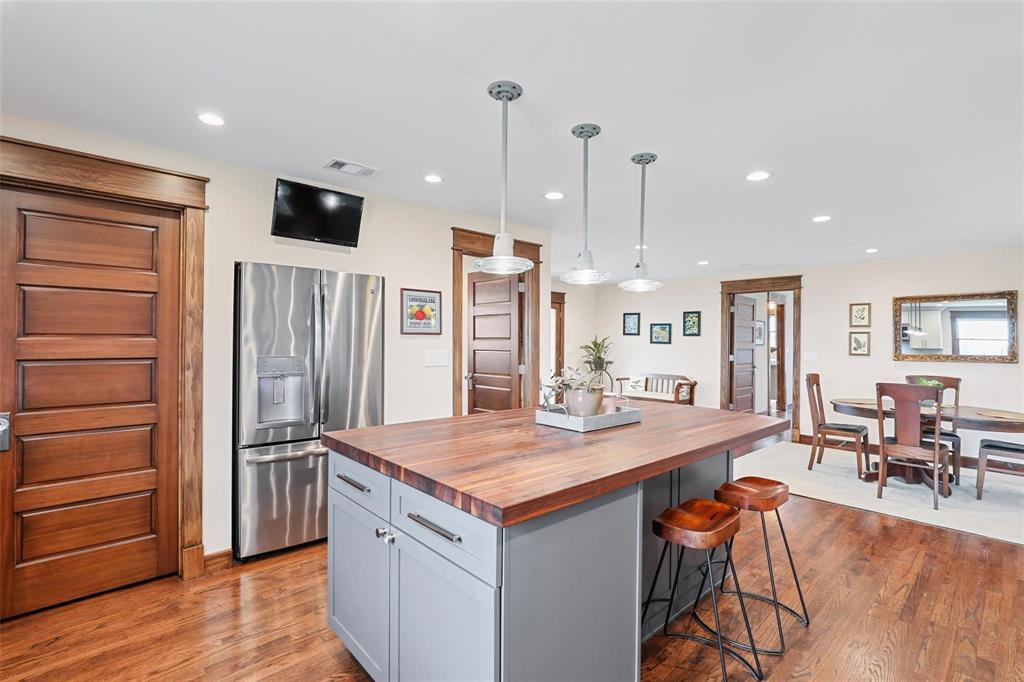 2196 Bledsoe Road Gunter, TX 75058 - Photo 9 of 33 a kitchen with stainless steel appliances kitchen island granite countertop a refrigerator and a stove top oven