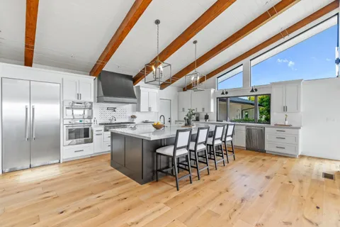 a spacious bedroom with a bed and a large window