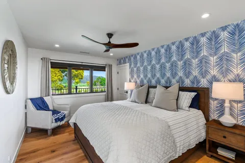 a bedroom with a bed window and couch