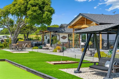 a front view of a house with swimming pool having outdoor seating
