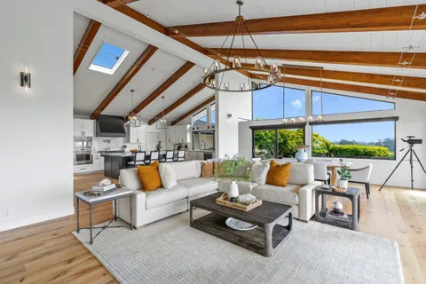 a living room with furniture a fireplace and a table