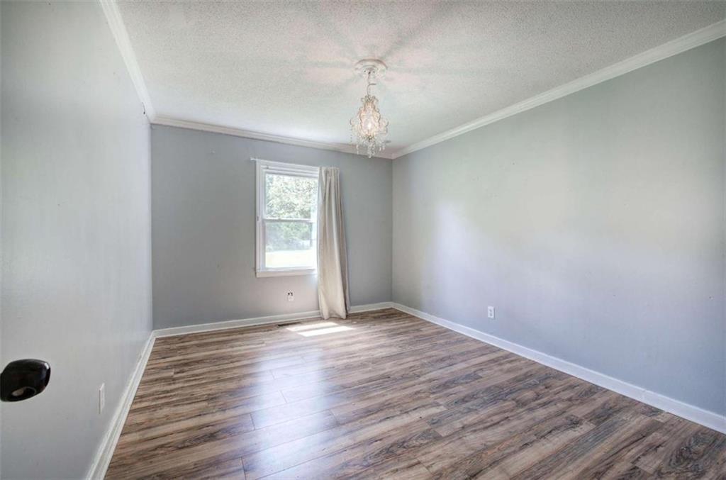 60 Lee Street Rockmart, GA 30153 - Photo 11 of 21 a view of an empty room with wooden floor and a window
