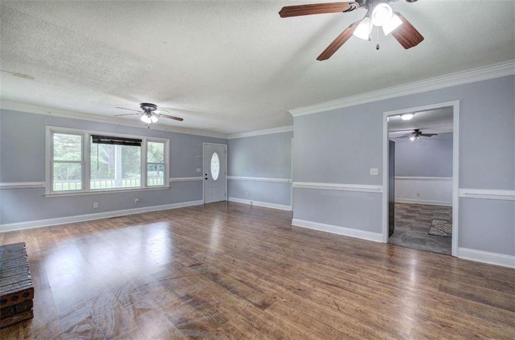 60 Lee Street Rockmart, GA 30153 - Photo 18 of 21 an empty room with wooden floor chandelier and windows