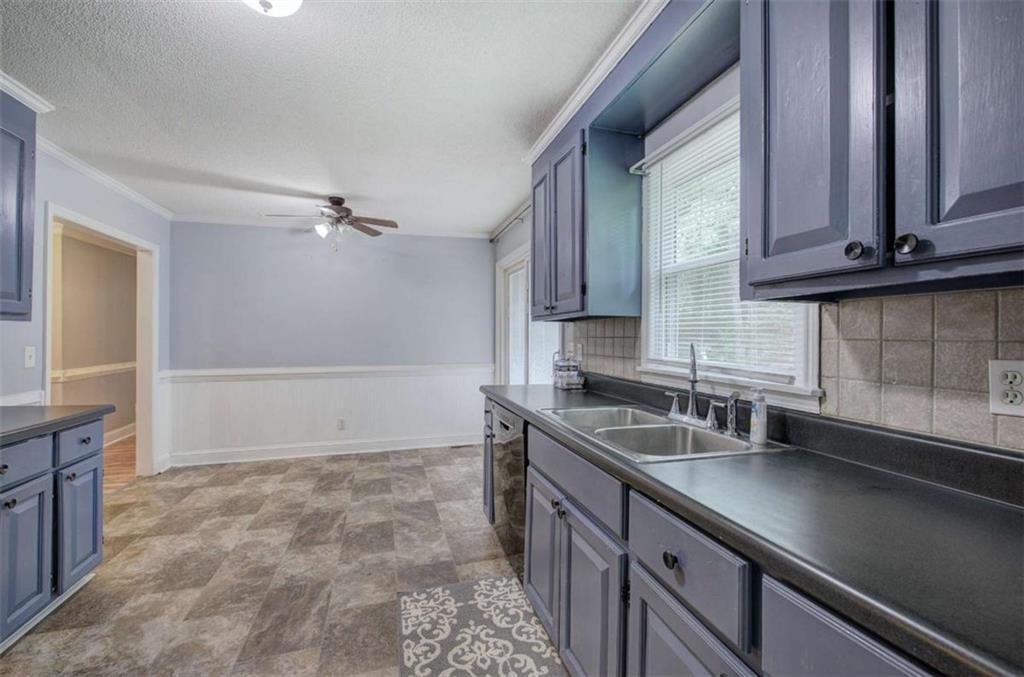 60 Lee Street Rockmart, GA 30153 - Photo 2 of 21 a kitchen with granite countertop a sink and a stove