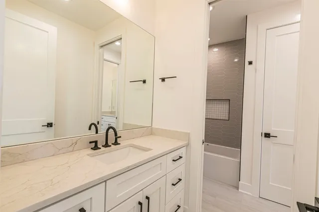 a bathroom with a sink a toilet and a mirror