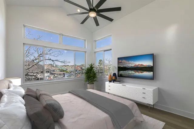 a bedroom with a bed and a flat screen tv