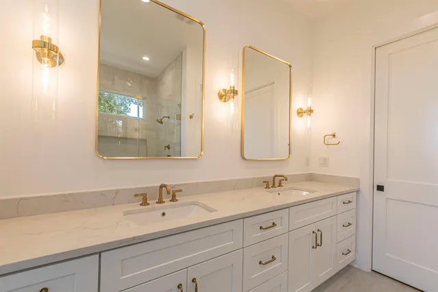 a bathroom with double sink and a mirror