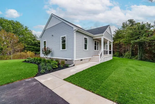 a front view of house with yard and green space