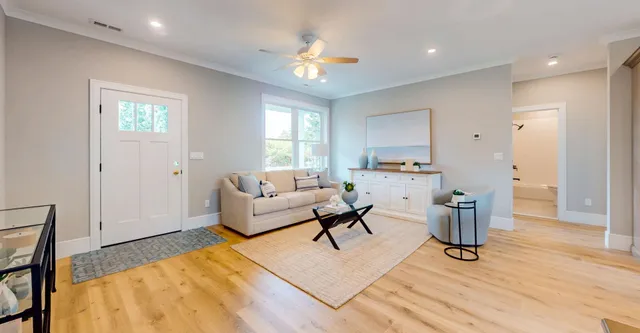 a living room with furniture and a chandelier