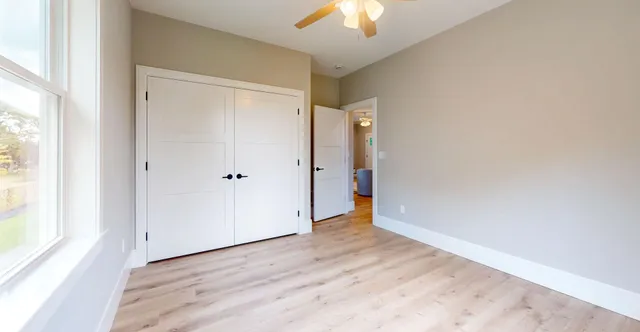 wooden floor in an empty room with a window