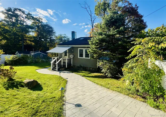 a view of a house with yard and sitting area