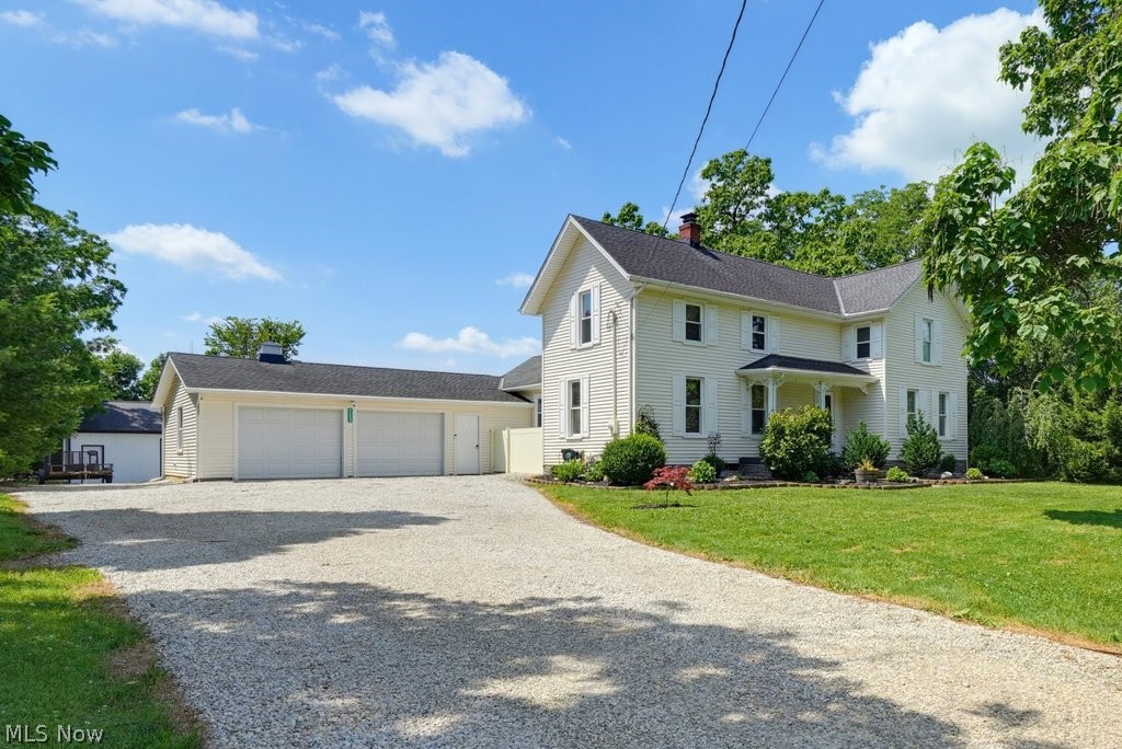 23055 Snell Road Columbia Station, OH 44028 - Photo 7 of 50 White exterior residence with a dark shingle roof and a spacious gravel driveway